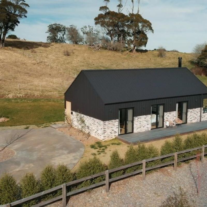 The Barn, Glenquarry NSW, designed by Solis Haus Building Design.  Roofing and Walling made from COLORBOND® steel in colour Monument® Matt