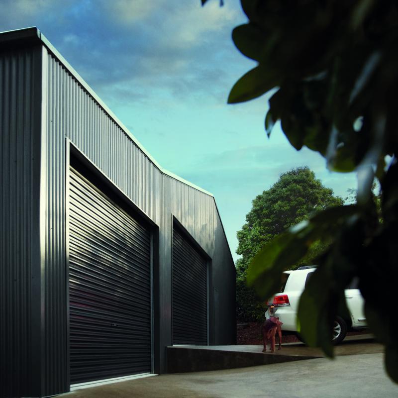 Car enthusiast Shed. Roofing and Walling made from COLORBOND® steel in colours Woodland Grey®.  Roller doors made from COLORBOND® steel in colour Monument®