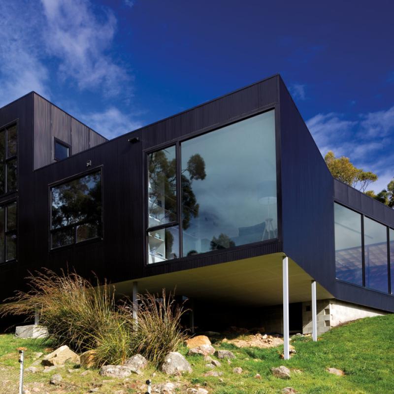 Residential house in Allens Rivulet, Tasmania. Cladding: LYSAGHT PANELRIB profile made from COLORBOND® steel in the colour Night Sky®. Room11 Architects