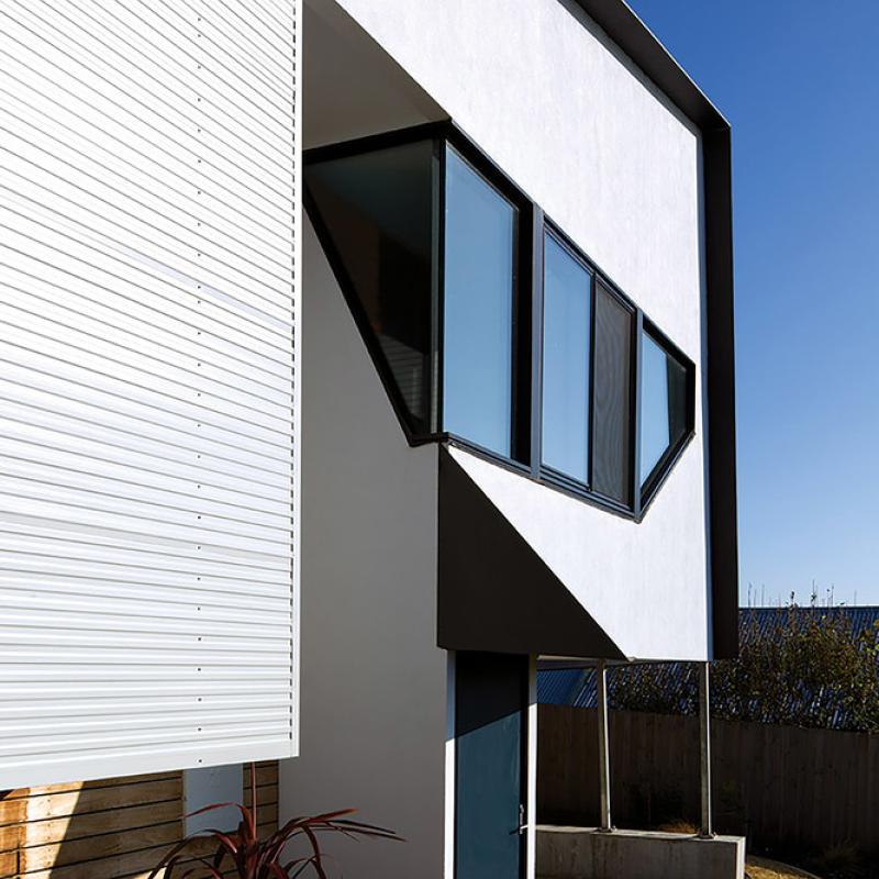 Home in Port Fairy, Victoria. walls are clad in COLORBOND® steel in the colour Shale Grey® and the profile LYSAGHT® PANELRIB®. skillion roof made from COLORBOND® steel in the colour Ironstone®. WSH Architects