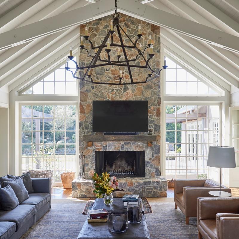 Living room with stone fireplace of home