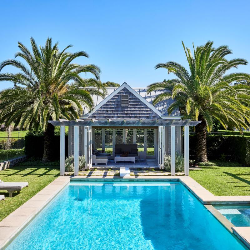 Swimming pool with grass surrounding and pool house with COLORBOND steel