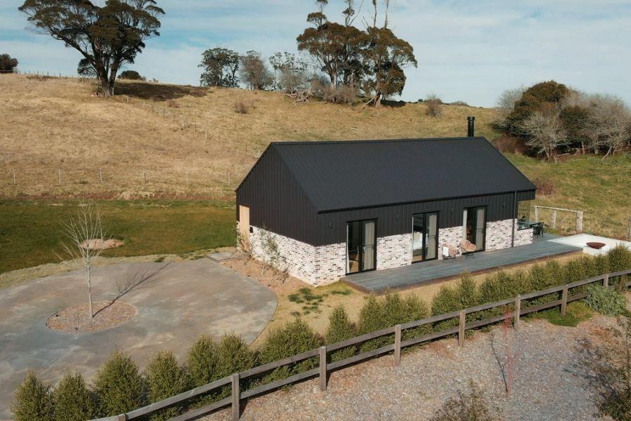 The Barn, Glenquarry NSW, designed by Solis Haus Building Design.  Roofing and Walling made from COLORBOND® steel in colour Monument® Matt