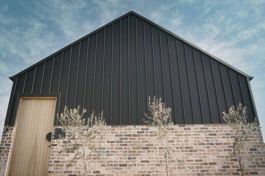 The Barn, Glenquarry NSW, designed by Solis Haus Building Design.  Roofing and Walling made from COLORBOND® steel in colour Monument® Matt