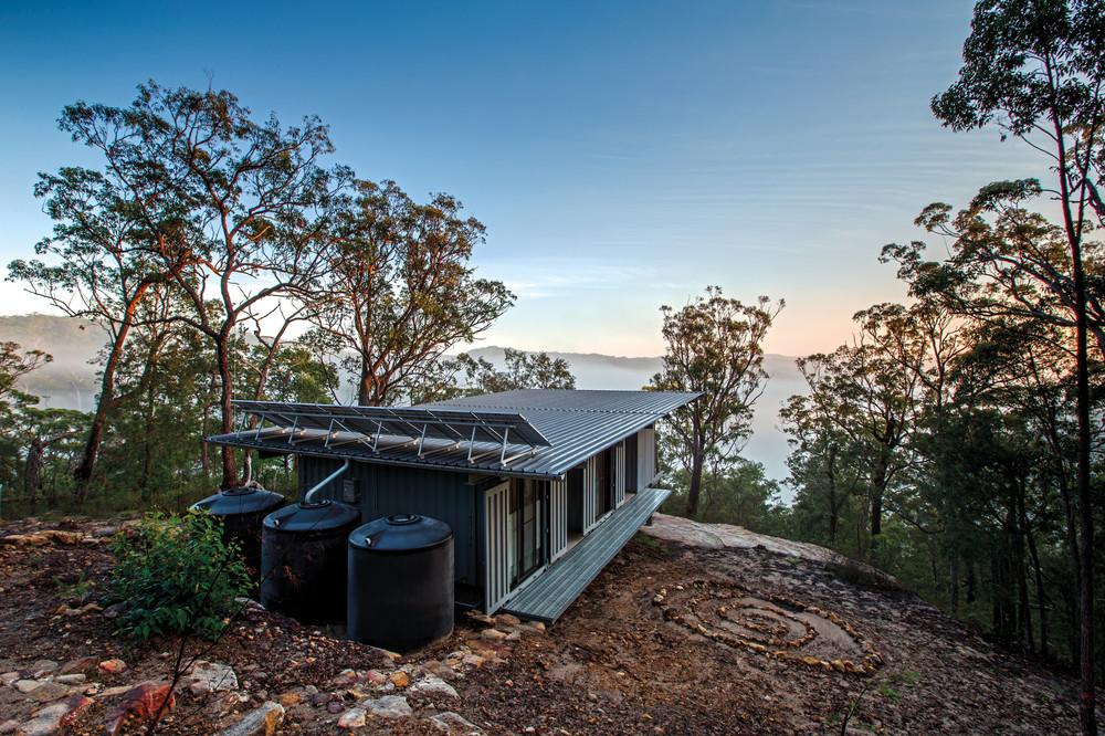 Residential home in Central Coast Hinterland, NSW. Roofing made from COLORBOND® steel in LYSAGHT KLIP-LOK® 700 profile in the colour Ironstone®. Drew Heath Architect 