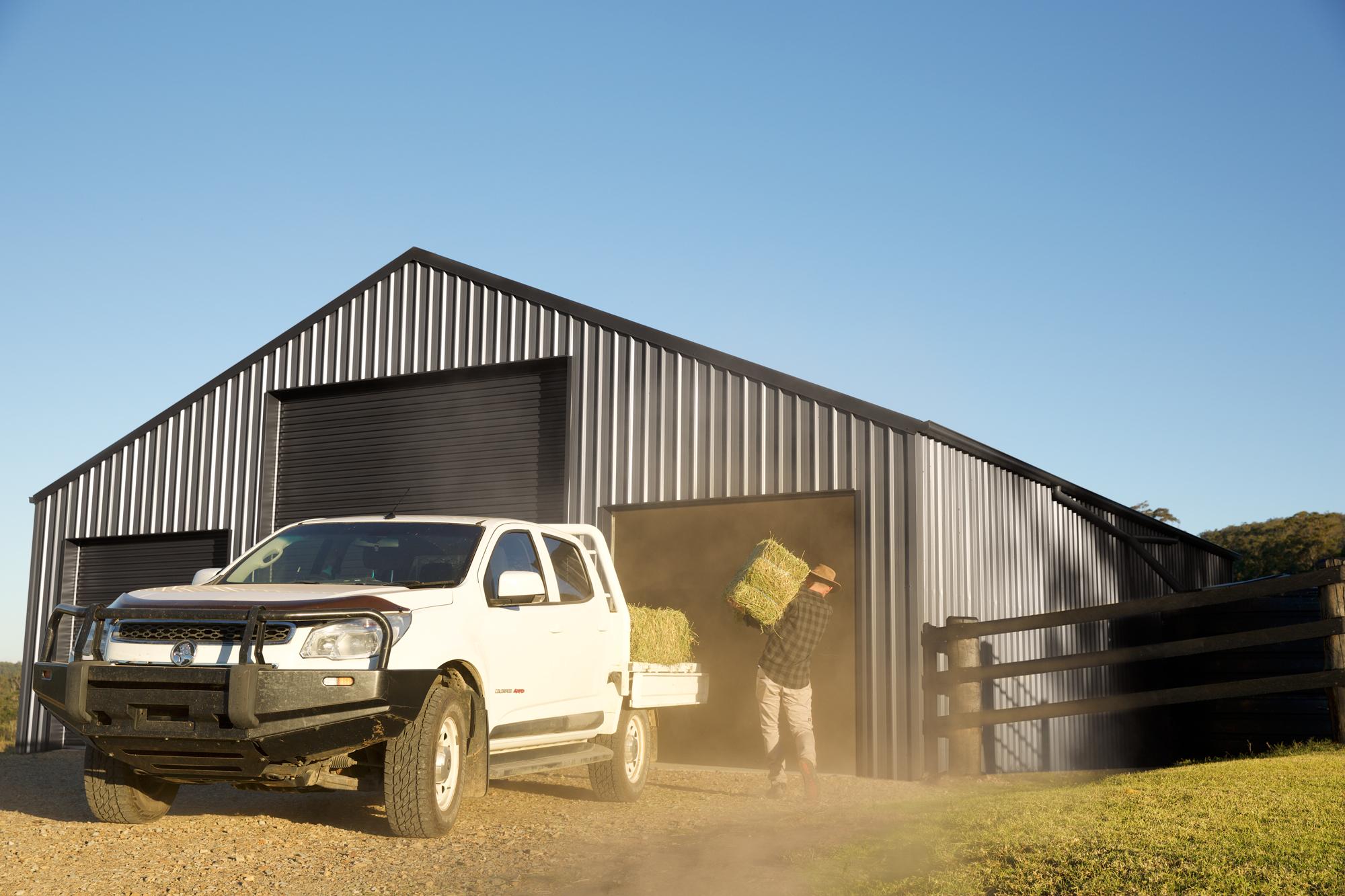 COLORBOND® steel. Tree Change. Farmer unloading hay bale infront of a Farm Barn. Flatlay Inspiration.