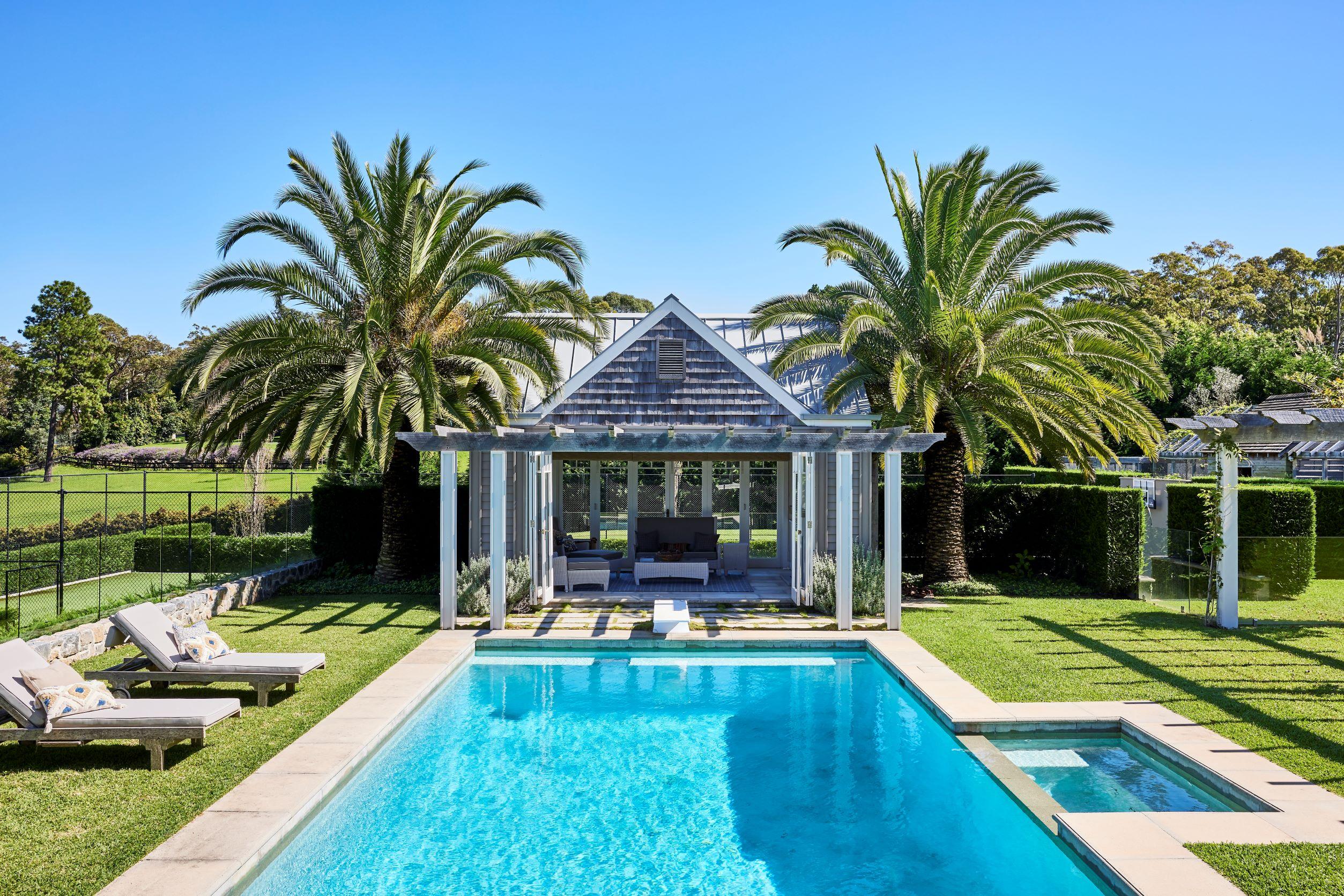 Swimming pool with grass surrounding and pool house with COLORBOND steel