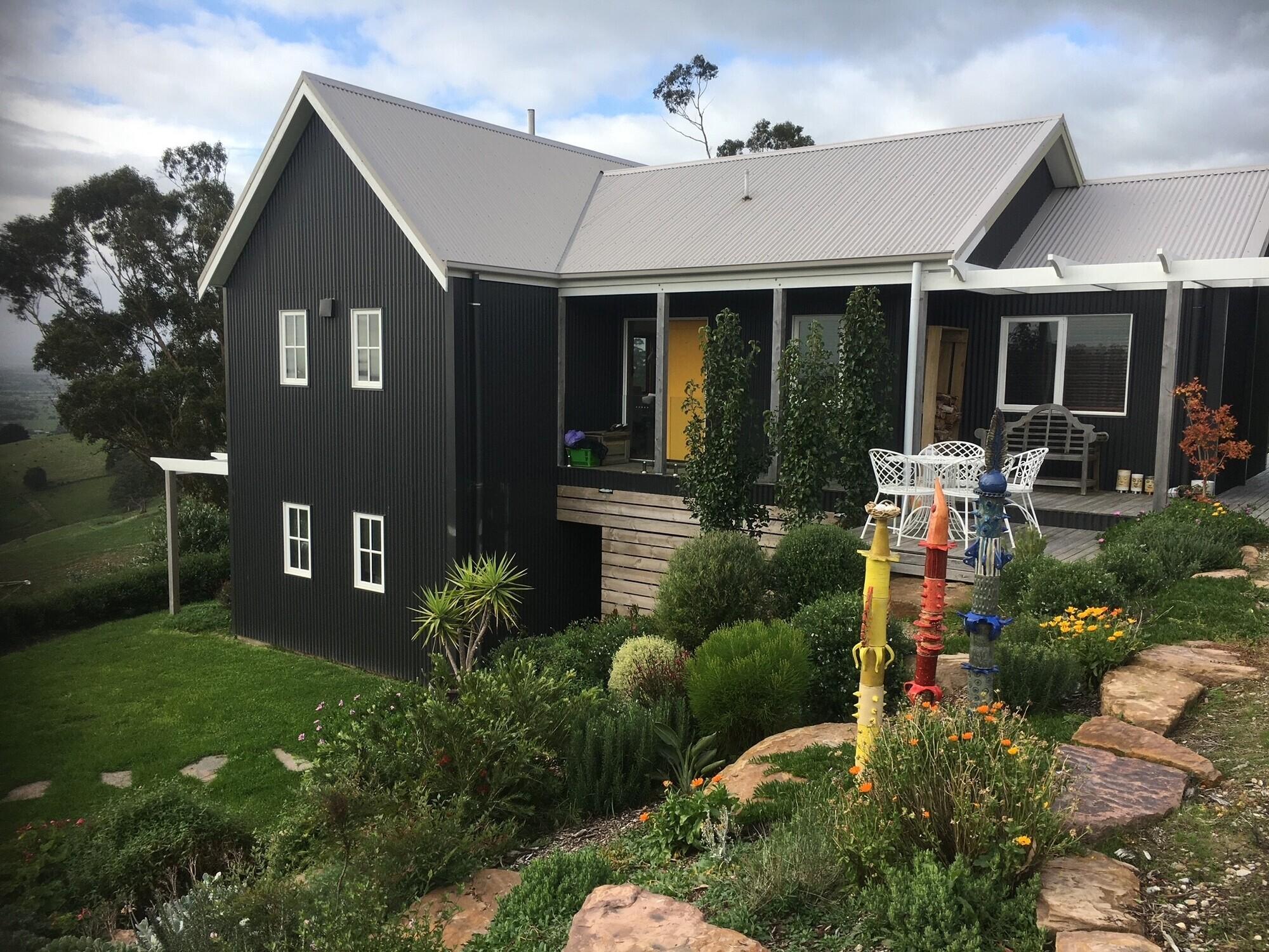 Peter from Yarragon, VIC loves COLORBOND® steel. Off grid house clad in COLORBOND® steel colour Monument® and Dune®