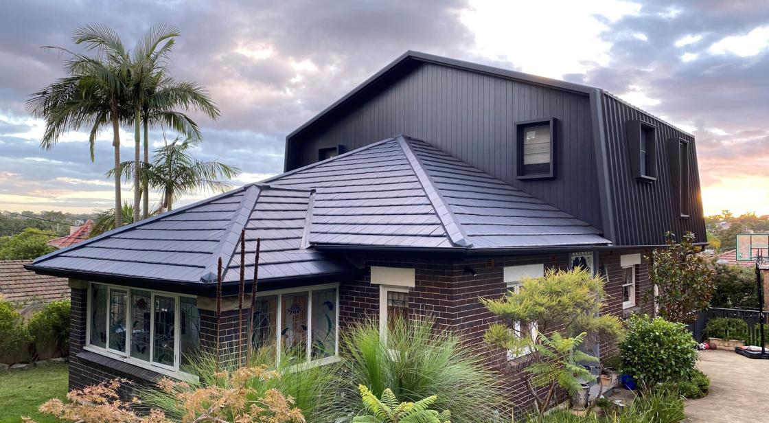 Standing seam in "Night Sky Matt" turns a 70s mansard modern