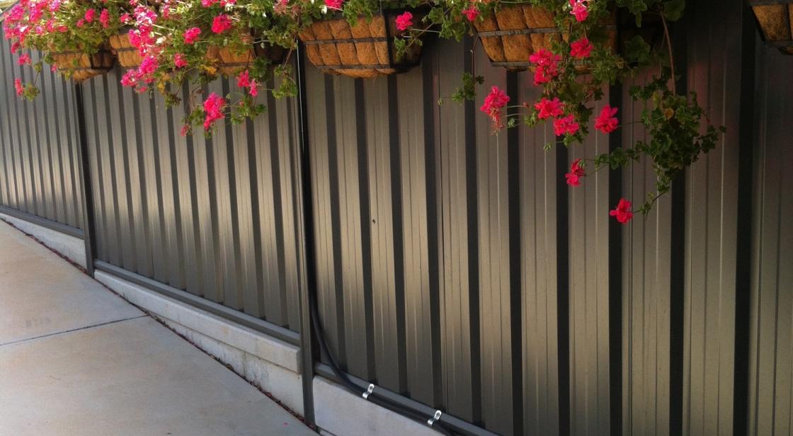 This COLORBOND fence was used to display with good effect hanging baskets of Geraniums adjacent to our drive where no garden would be possible.