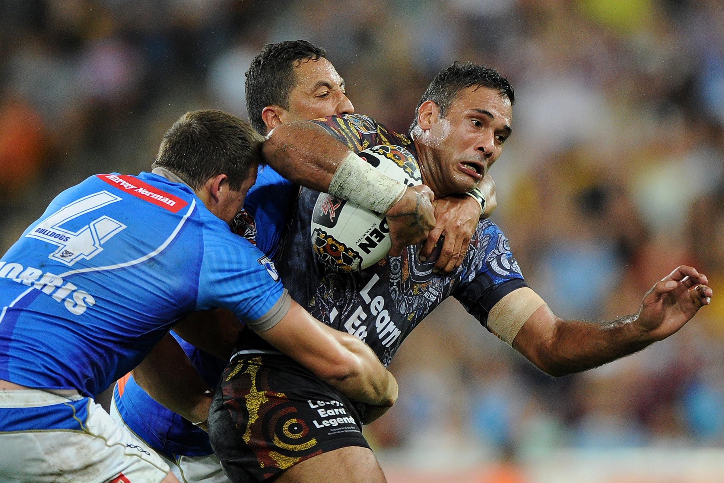 Justin Hodges of the Indigenous All Stars is tackled during the NRL All Stars Game