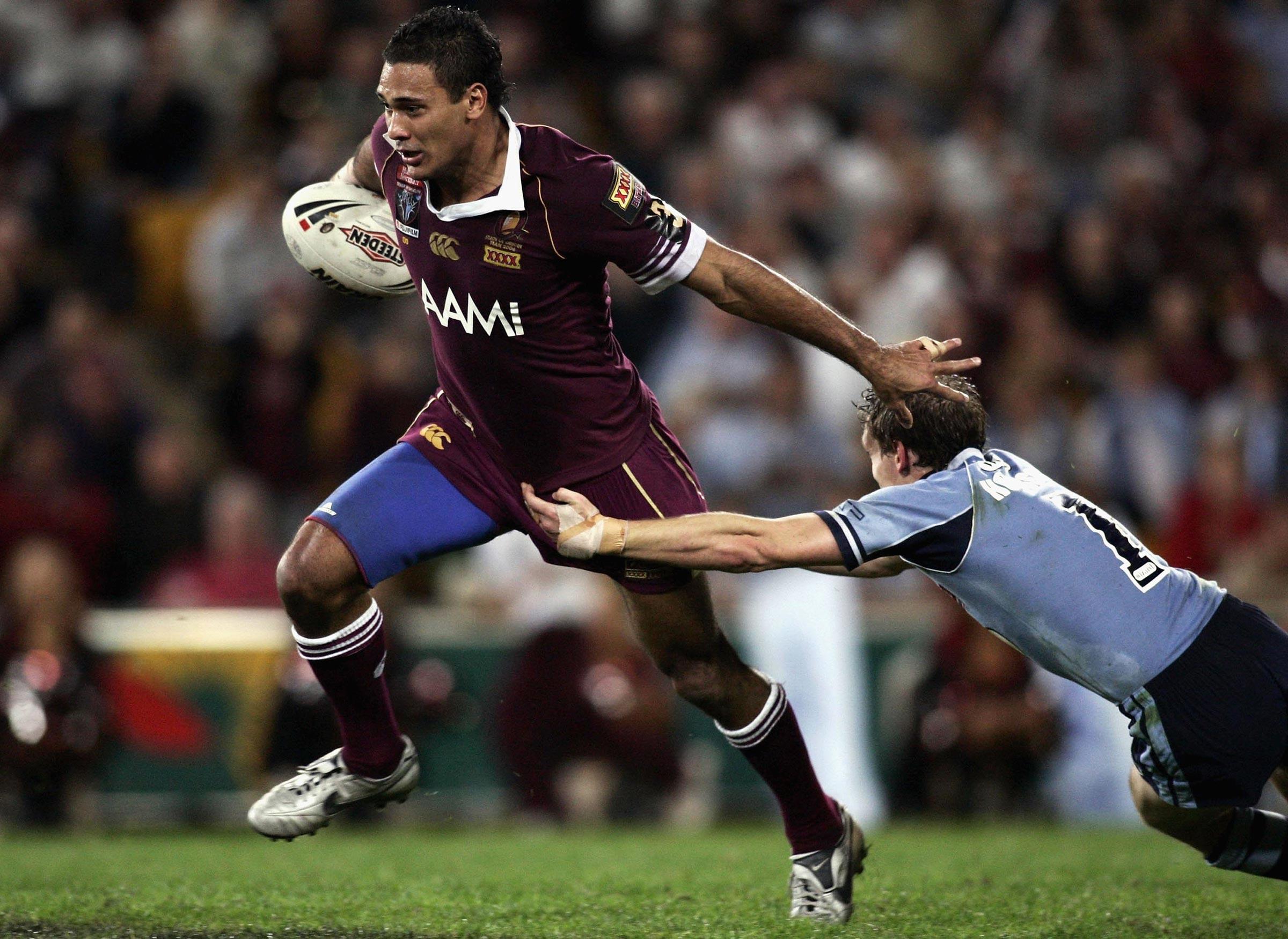 Justin Hodges of the Maroons breaks through the Blues defence
