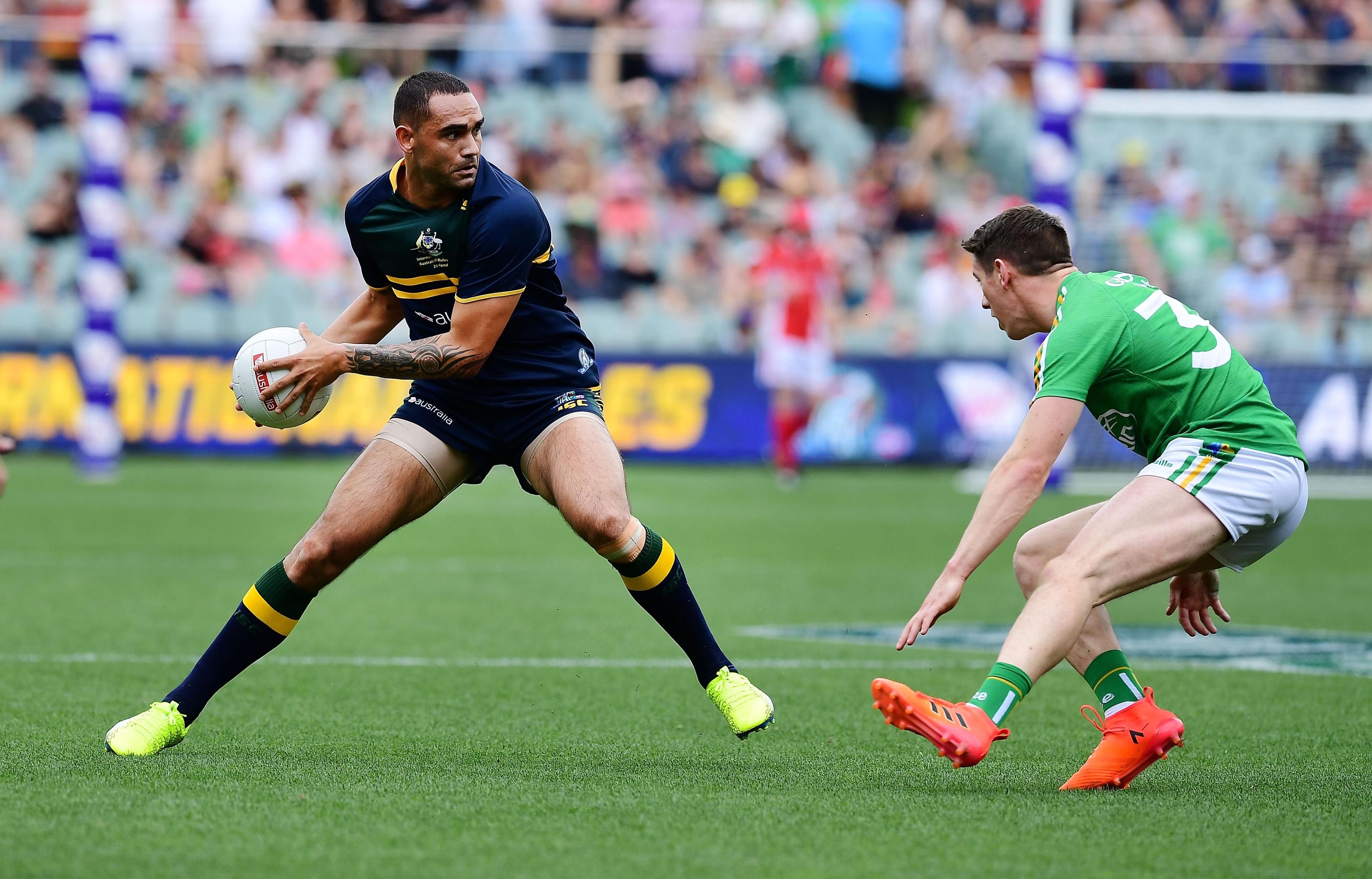Shaun Burgoyne of Australia competes with Shane Walsh