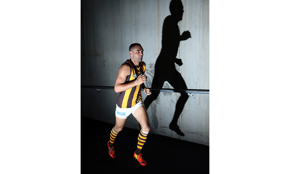 Shaun Burgoyne of the Hawks runs onto the field 